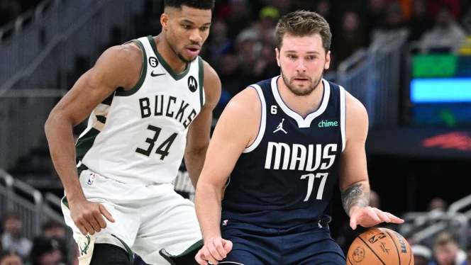 
					Luka Doncic dribbles vs Giannis Antetokounmpo