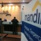 Bank Mandiri memberikan penjelasan mengenai kredit kepada Jhonlin Baratama dan penggunaan saham JARR serta PGUN sebagai agunan.