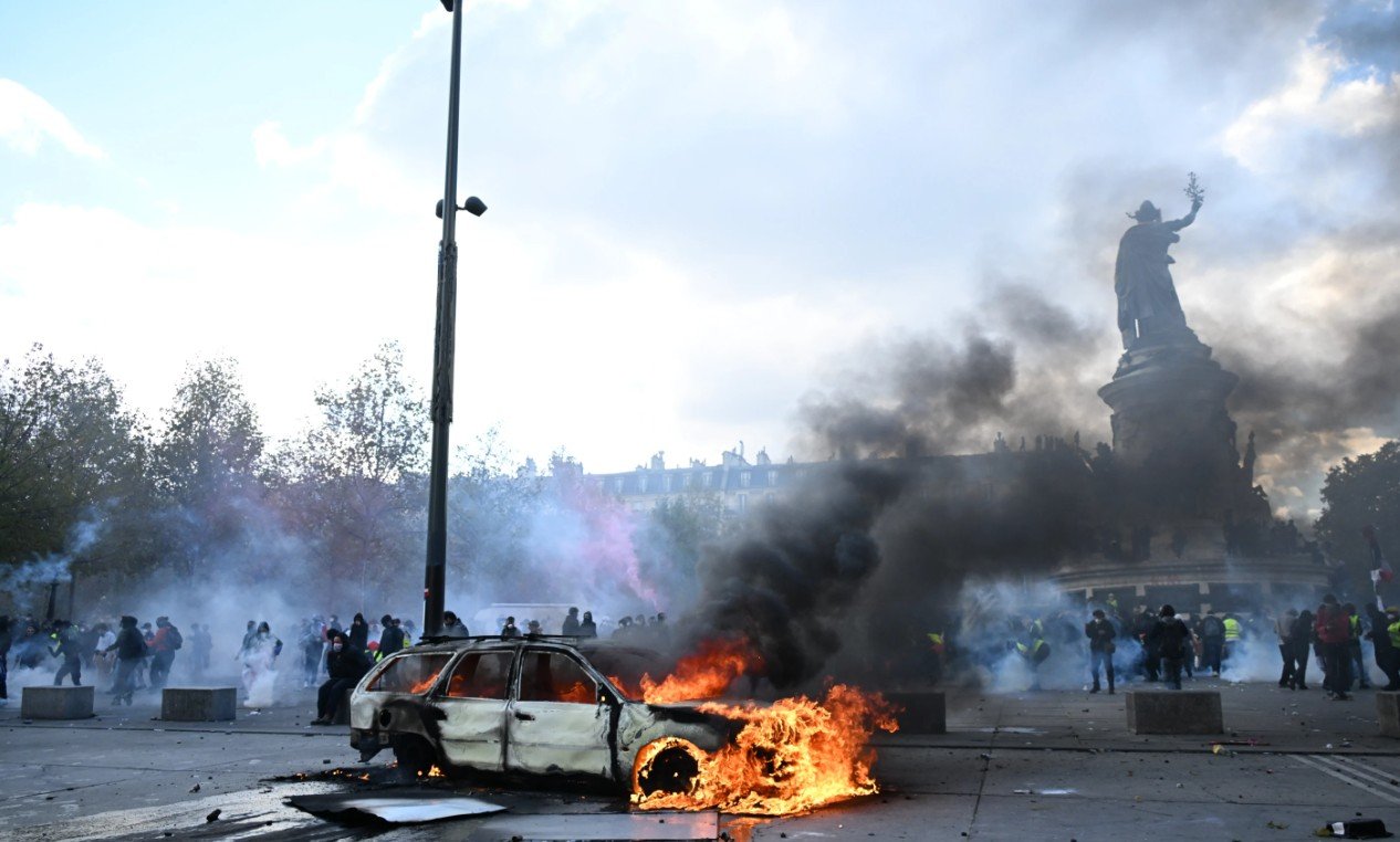 Sebuah mobil terbakar di Place de La Republique selama aksi protes menentang kenaikan biaya hidup di Paris, Perancis. Sabtu, 17 Oktober 2026. (AP Photo/Emma Da Silva)