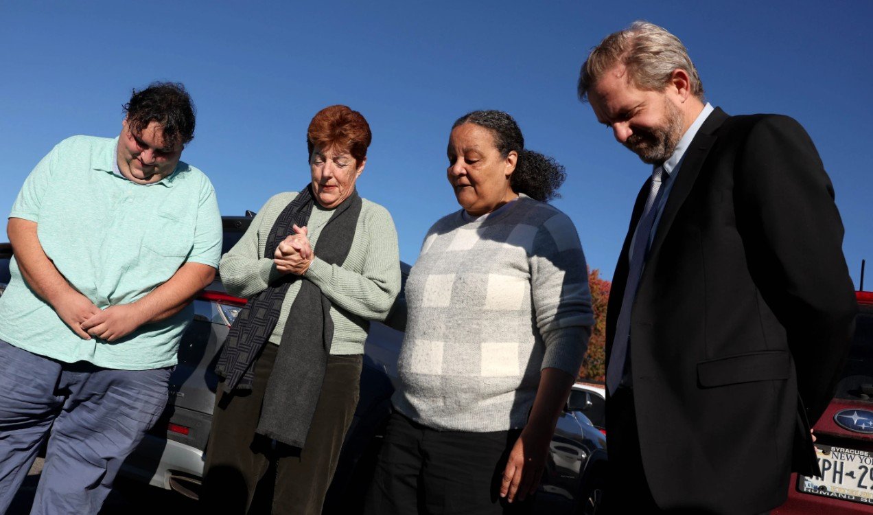 Marva Cook, dua dari kanan, di luar kantor Imigrasi dan Penegakan Bea Cukai AS (ICE) di Syracuse, N.Y., AS. Rabu, 21 Oktober 2026. (The Post-Standard/Dennis Nett)